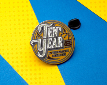 Circular InterNACHI Ten Year Member lapel pin with black and gold enamel on a blue and yellow background.